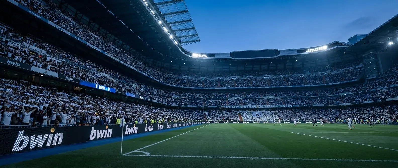 Estadio lleno en una noche europea de fútbol con branding de Bwin en las bandas